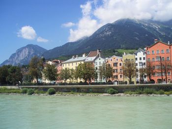 Scenic view of river and mountains against sky