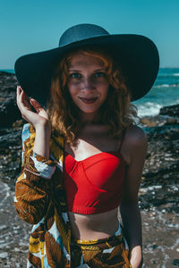 Portrait of fashionable woman standing on beach