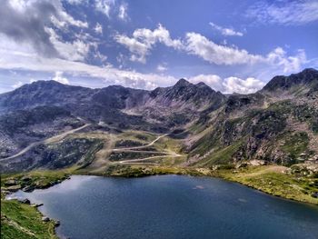 Scenic view of lake and mountains against sky