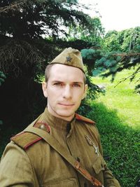 Portrait of young man standing in forest