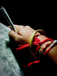 Close-up of human hand against black background