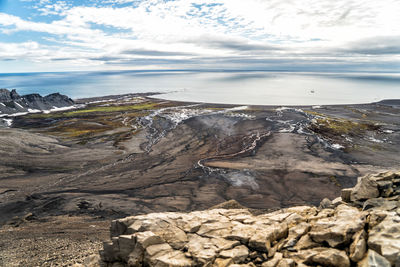 Aerial view of rocks on land against sky