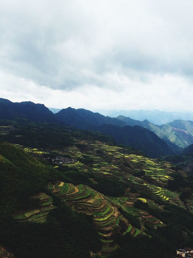 mountain, mountain range, sky, landscape, tranquil scene, scenics, tranquility, cloud - sky, beauty in nature, nature, cloudy, high angle view, cloud, green color, non-urban scene, tree, hill, idyllic, outdoors, day