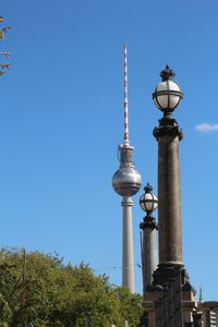 Low angle view of communications tower against sky