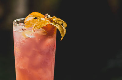 Close-up of drink on glass against black background