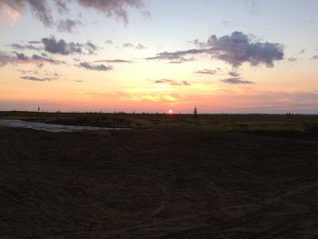 Scenic view of field against sky during sunset