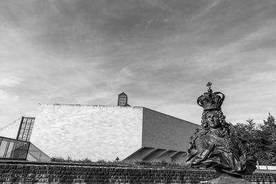 Statue against cloudy sky