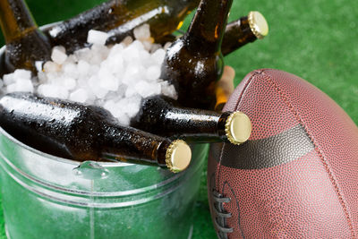 Close-up of beer bottles in container