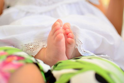 Low section of baby girl sitting at home