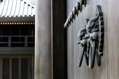 Close-up of metal hanging on door of building