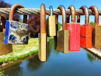 Close-up of padlocks hanging on metal