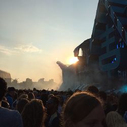 High angle view of crowd gathered for music concert during sunset