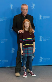 Young couple standing against wall