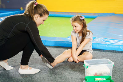 Woman treating injury of girl