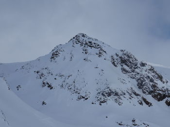 Scenic view of snow covered mountains against sky