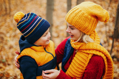 Woman with son at forest during autumn