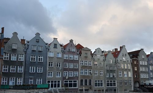 Low angle view of houses in town against sky