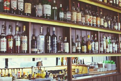 Row of bottles on shelf at bar