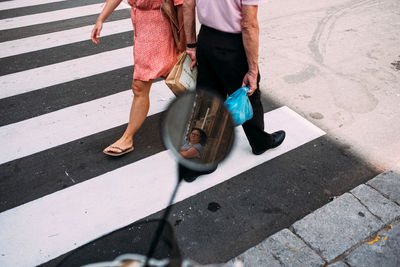 Low section of people walking on road