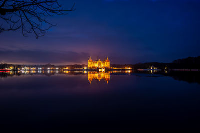 Illuminated city at waterfront