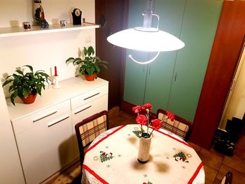 Illuminated light bulb on table at home