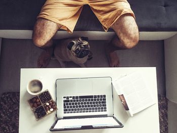 High angle view of man using laptop on table