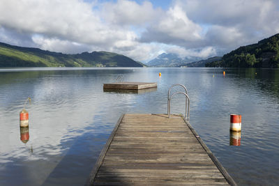 Pier on lake against sky