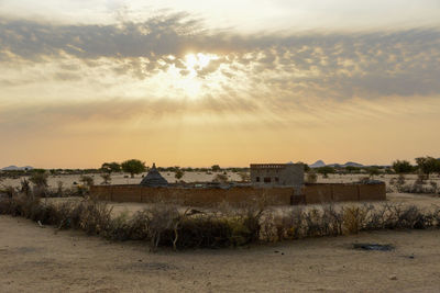 Scenic view of field against sky during sunset