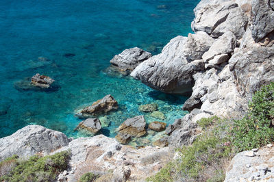 High angle view of rocks by sea