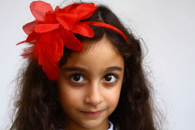 Close-up portrait of a smiling girl over white background