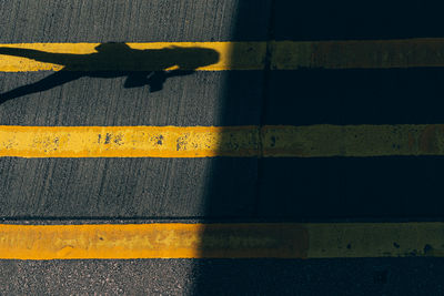 Shadow of person on street