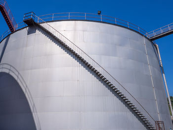 Low angle view of storage tank against clear sky