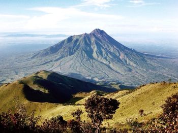 Scenic view of mountains against cloudy sky