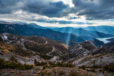 Scenic view of mountains against cloudy sky