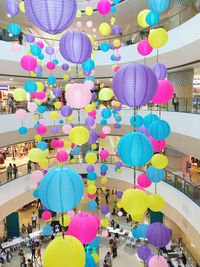 Low angle view of multi colored umbrellas hanging on ceiling