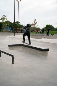 Full length of man skateboarding on skateboard against sky