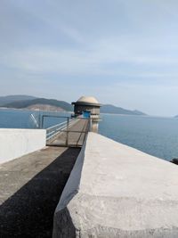 Lifeguard hut in sea against sky