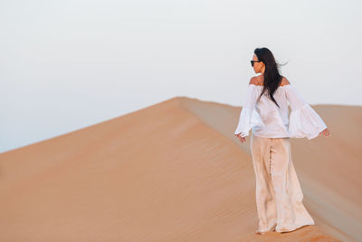 Woman standing in a desert
