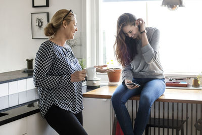 Young woman sitting with coffee cup on table