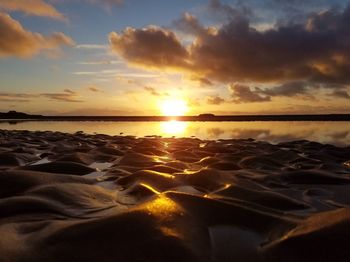 Scenic view of beach against sky during sunset