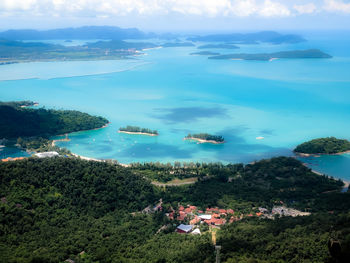 High angle view of sea and buildings against sky