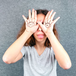 Funny girl with eyes drawn on her palms. april fools joke