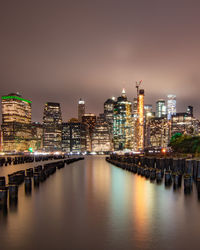 Illuminated city buildings at waterfront