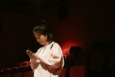 Young woman using mobile phone at home