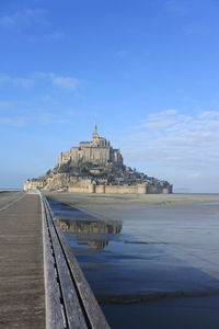 Building by sea against sky  m'ont saint michel normandy