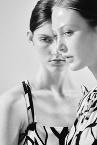 Close-up portrait of young woman over white background