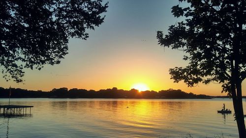 Scenic view of lake against sky during sunset