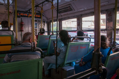 Rear view of people traveling in bus