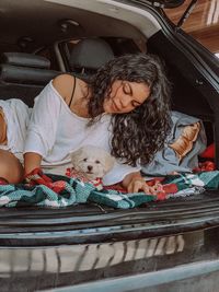 High angle view of cute girl sitting in car