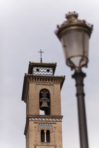 Low angle view of bell tower against sky